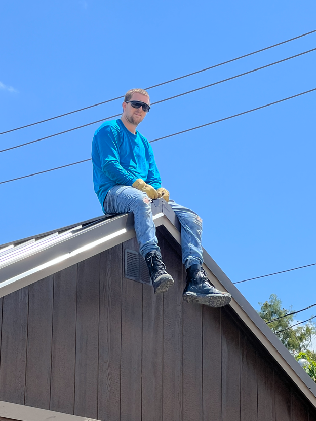 Crew member sitting on a house